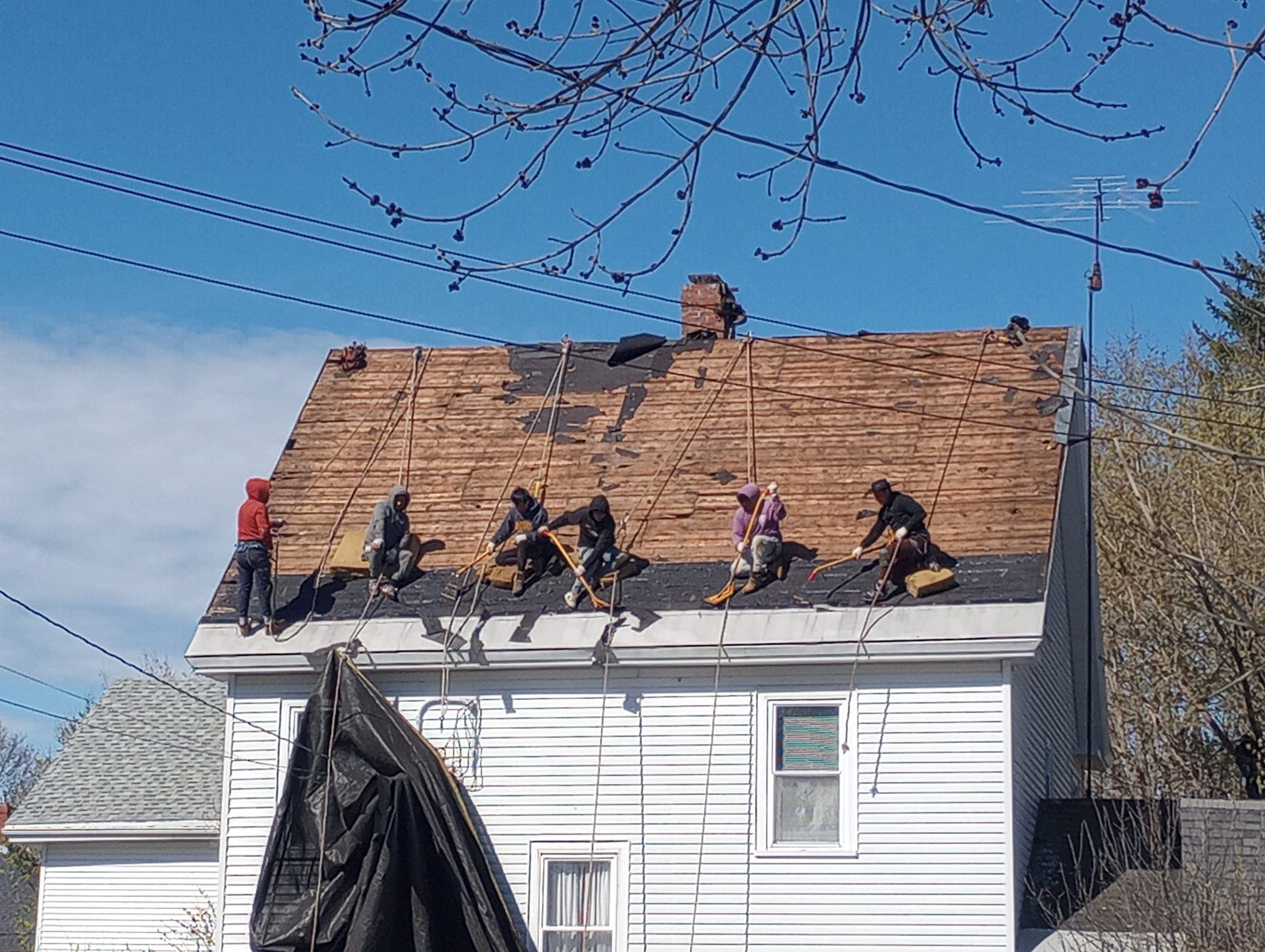 6 Roof Inc. Roofer's stripping an old roof.