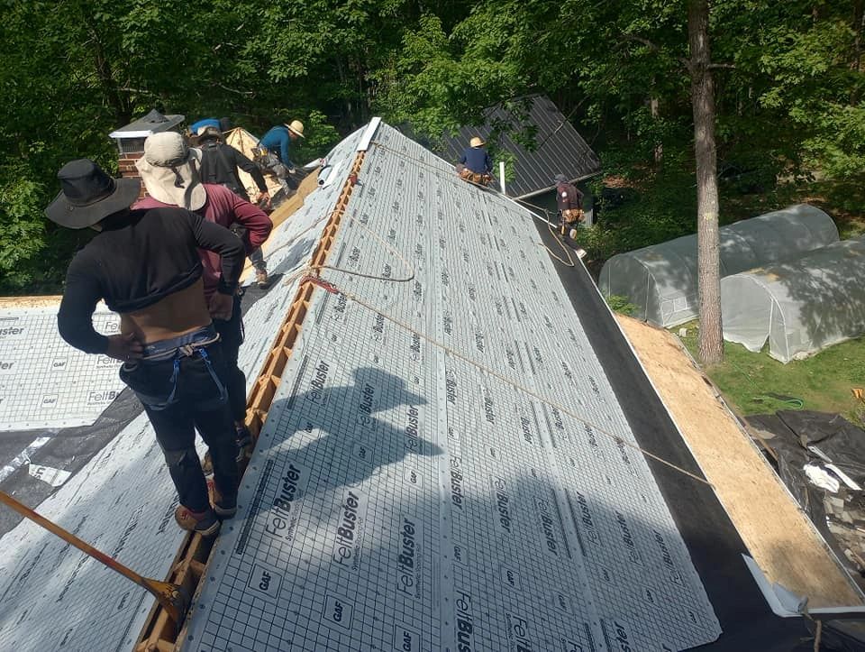 Roof Inc. crew is installing GAF Ice and water shield and GAF synthetic felt paper on a roof.